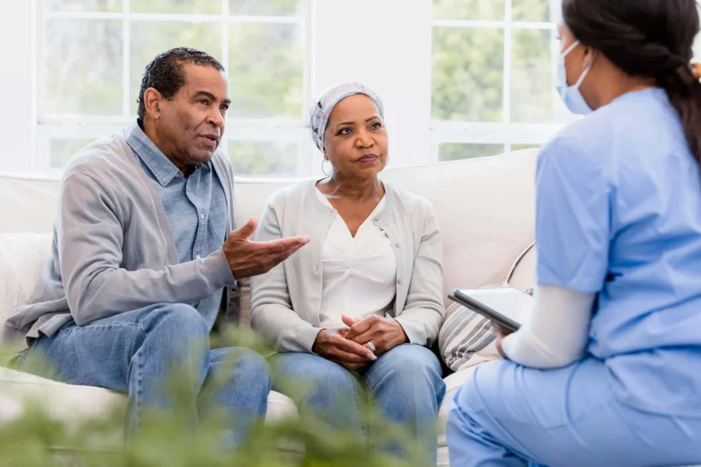 Senior couple explaining and talking to a nurse