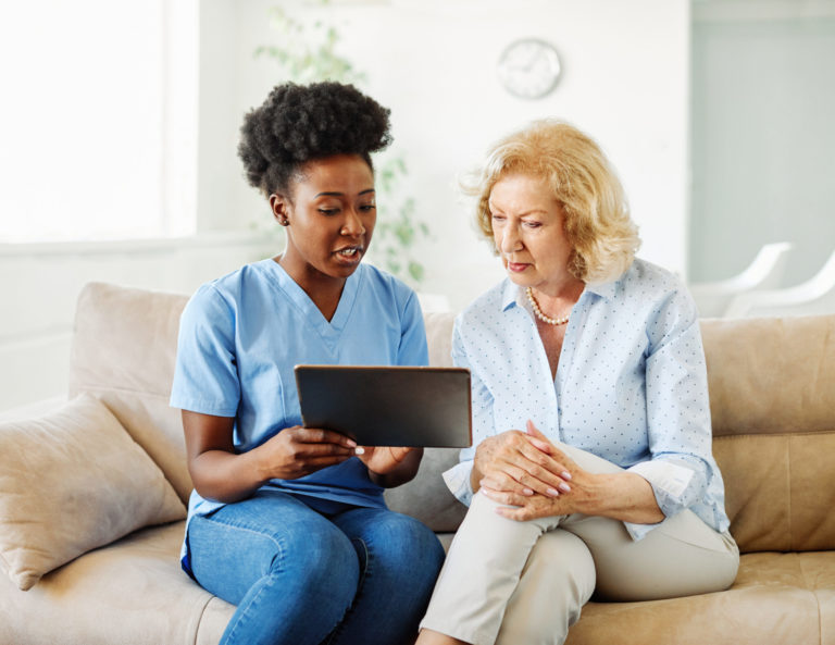 nurse doctor senior care tablet computer technology showing care